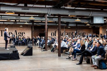 A man speaking in front of an audience.